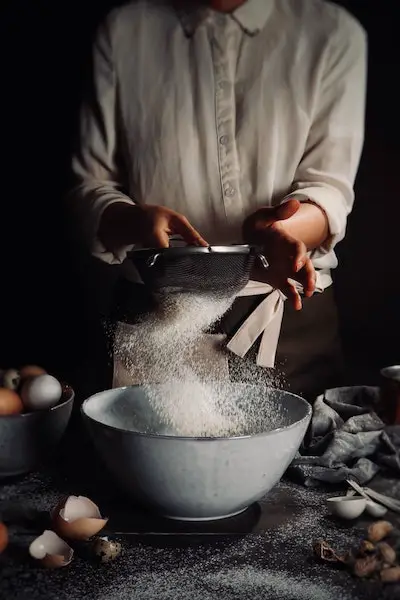 sifting flour from milling grains for bread making